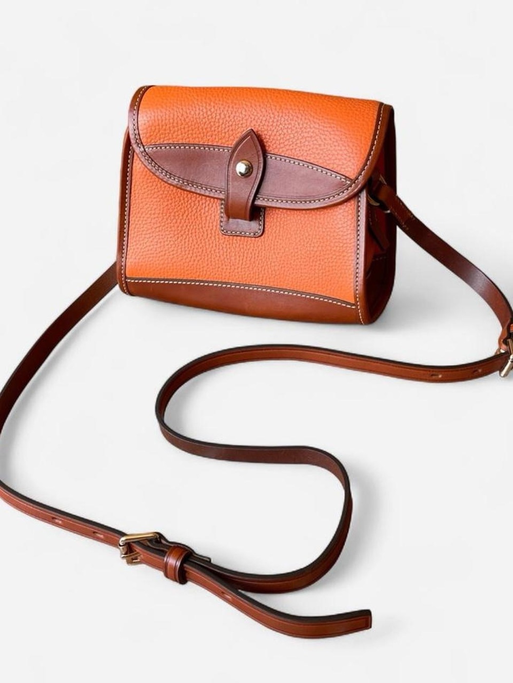 Dooney & Bourke orange and brown pebbled all weather leather crossbody purse